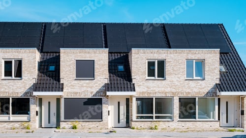 Aperçu: Newly build houses with solar panels attached on the roof against a sunny sky