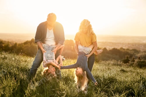 Preview: Family with two daughters have fun at the meadow during the sunset