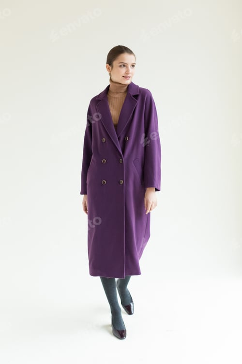 Preview: Young beautiful stylish woman in studio in coat, autumn fashion trend.
