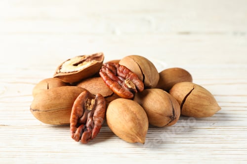 Preview: Tasty pecan nuts on white wooden background