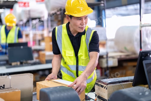 Preview: Worker working in the large depot storage warehouse happy smiling packing box at cashier counter