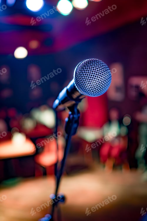 Preview: Microphone on stage against a background of auditorium.