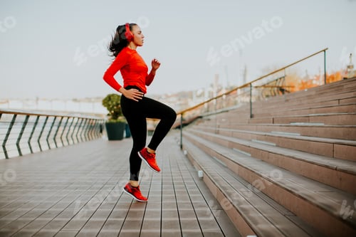 Preview: Young woman exercising outside