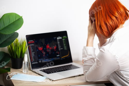 Preview: Sad woman is looking at falling stock charts during an epidemic covid-19