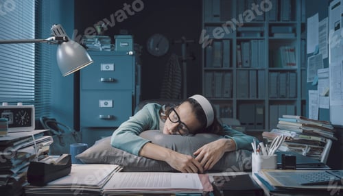 Preview: Exhausted office worker sleeping at her desk