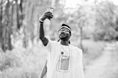 Preview: Happy cheerful black african couple in love doing selfie on they phone