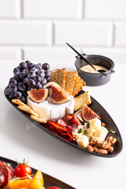 Preview: Assorted cheese, prosciutto, nuts, snacks and fruits. Delicious appetizers