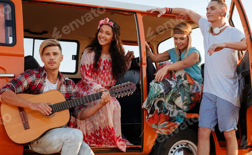 Preview: Hippie friends with guitar on a road trip