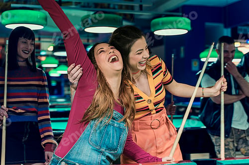 Preview: Friends enjoying a game of billiards - Laughter and fun in the game room
