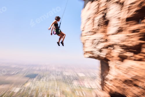 Preview: Sports, rock climbing and jump with woman on mountain for fitness, adventure and challenge. Fearles