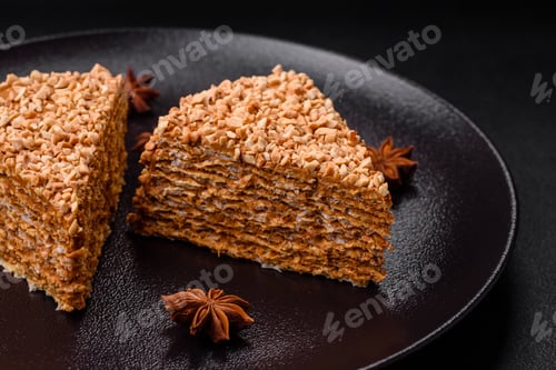 Preview: Delicious sweet puff waffle cake with cream and nuts cut into pieces