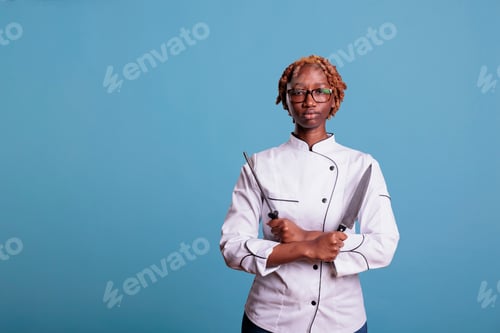 Preview: Chef holding knife and sharpener with arms crossed