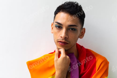 Preview: Young Adult Posing with Pride Flag Indoors
