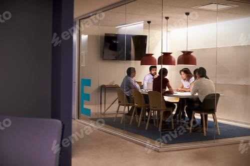 Preview: Corporate business team at table in a meeting room cubicle