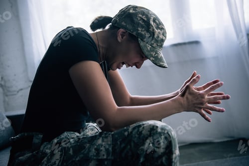 Preview: depressed woman in military uniform screaming at home