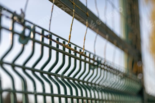 Preview: focus on a rusty fence bar