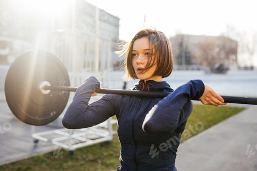 Preview: Strong woman exercising with barbell. Sports, fitness concept