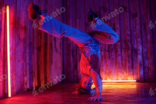 Preview: Performing Handstand in Vibrant Neon-Colored Room