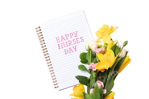 Preview: Flowers and a notepad show appreciation for nurses, isolated on white