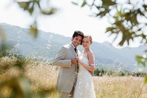 Preview: Newlyweds embracing in field