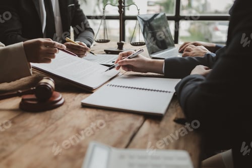 Preview: Business people negotiating a contract, discussing contract while working together in sunny modern o