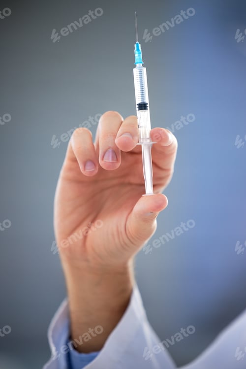 Preview: Hand, healthcare and closeup of needle, vaccine or shot for covid, disease or sickness on mockup. D