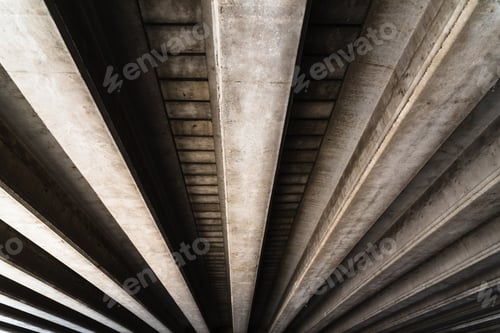 Preview: Cement beams support the weight of a bridge over a road.