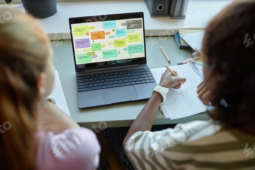 Preview: Two Girls Using Computer in Class with Colorful Chart on Screen