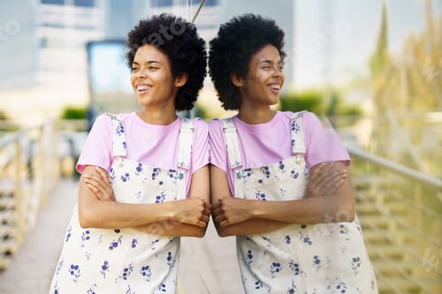 Preview: Funny black woman in casual clothes laughing in the street.