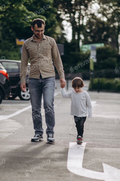 Preview: A boy with his dad follows a painted arrow on the asphalt