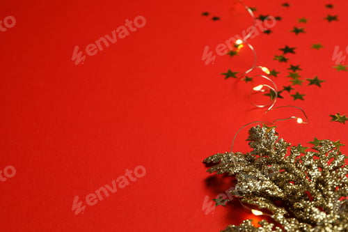 Preview: Garland and golden branch on red background, space for text