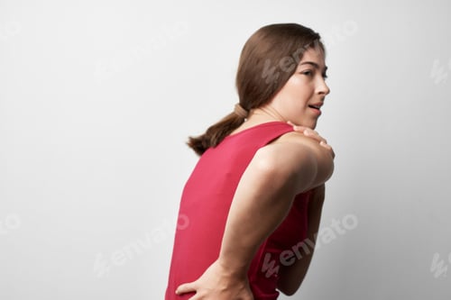 Preview: woman in red t-shirt holding her back health problems rheumatism medicine lifestyle