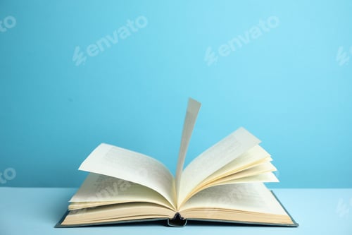 Preview: Open old hardcover book on light blue background