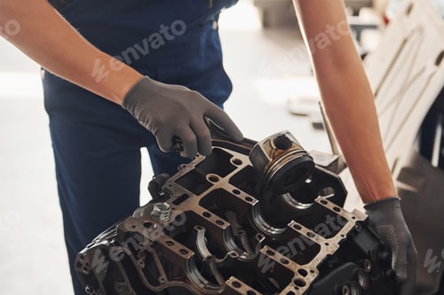 Preview: Professional repairman works with broken automobile engine