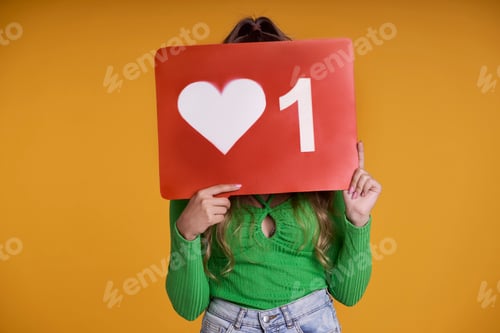 Preview: Caucasian teenage girl hiding behind a Like button