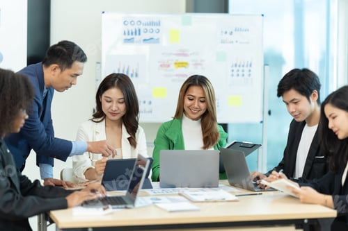 Preview: Business people showing team work while working in board room in office interior