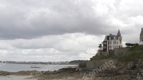 Preview: Panoramic aerial view of the cottages of white and red bricks located on the ledge by the sea shore