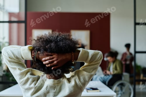 Preview: Businessman with hands on back of head