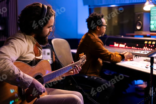 Preview: Musician composing new tracks on his electro acoustic guitar