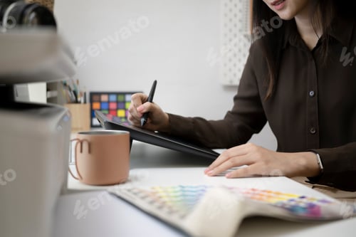 Preview: Cropped shot of female graphic designer working with digitizer tablet at creative office.