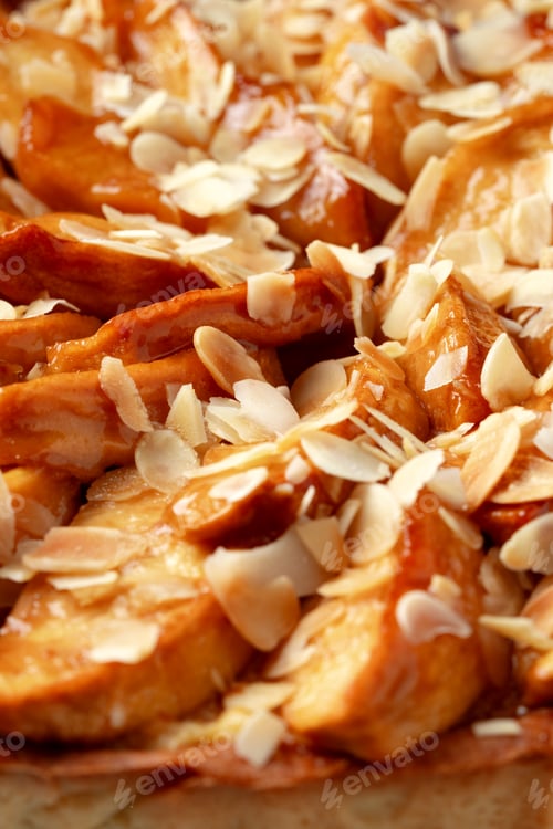 Preview: Fresh baked apple tart with sliced almonds for dessert in a cozy kitchen setting