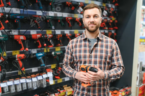Preview: Man shopping for drill in hardware store