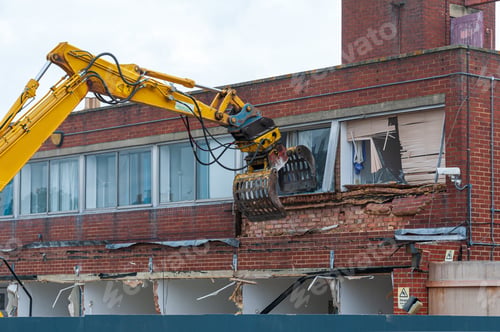 Preview: Demolition of an old building with a long reach machine hydraulic jaw.