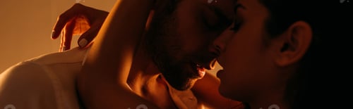 Preview: Passionate woman hugging businessman with closed eyes in bedroom, panoramic shot