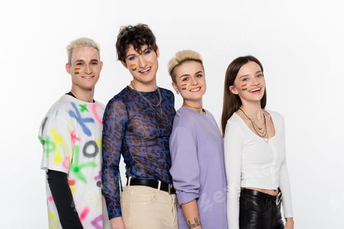 Preview: smiling lgbtq community friends with rainbow flags on faces looking at camera isolated on grey