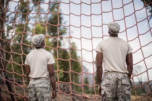 Preview: Military soldiers looking at net during obstacle course