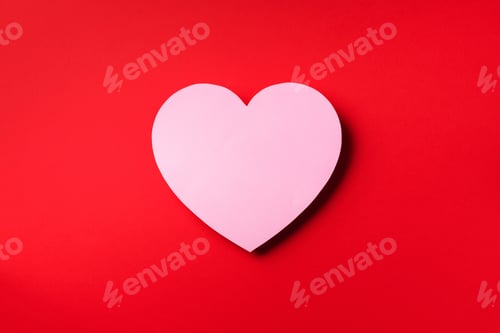 Preview: Pink heart cutted from paper over red background with copy space. Top view. Valentine's Day