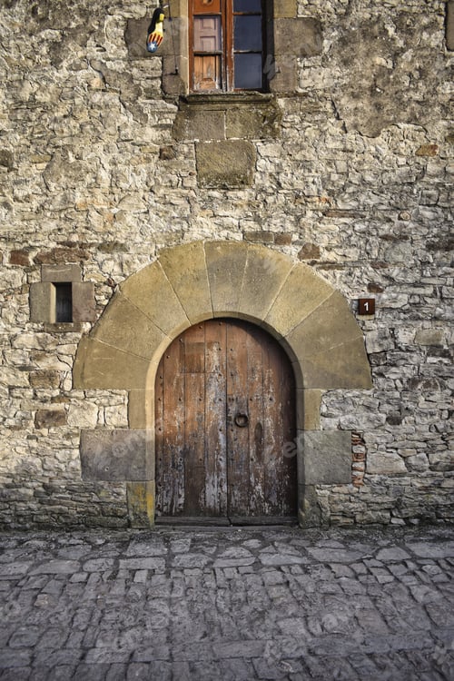 Preview: Vertical shot of an old stone building under sunlight