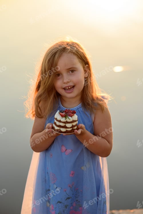 Preview: Smiling Girl Holding a Small Birthday Cake Outside