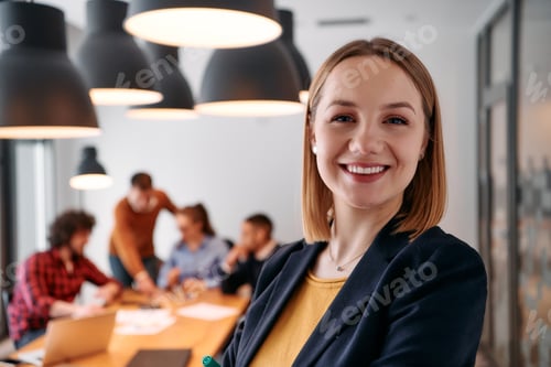 Preview: Confident Blonde Businesswoman Leading Team in Modern Office Setting.
